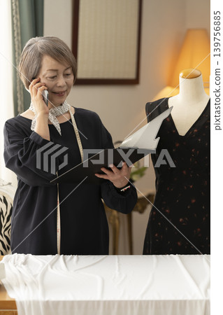 Senior female designers create clothes in their atelier. Senior female designers create clothes in their atelier. 139756885