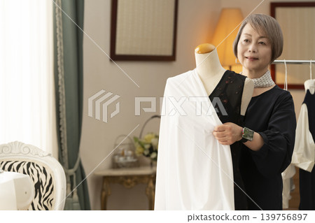 Senior female designers create clothes in their atelier. Senior female designers create clothes in their atelier. 139756897