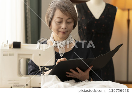 Senior female designers create clothes in their atelier. Senior female designers create clothes in their atelier. 139756928