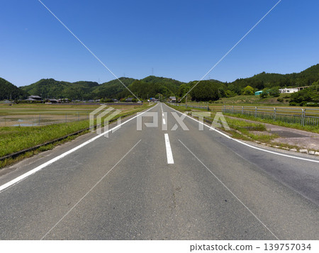 Scenery of a road running through a rural area Scenery of a road running through a rural area 139757034