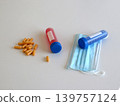 Medical composition with capsules, sample tubes and protective face mask for healthcare treatment and infectious disease concepts. Scientific scene for virus research and medical diagnostics. 139757124