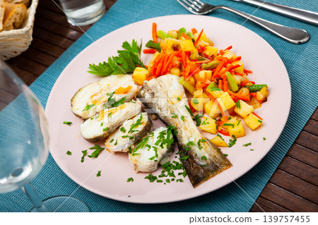 Oven baked hake with vegetable garnish Oven baked hake with vegetable garnish 139757455