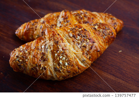 Fresh tasty multigrain croissants on table in kitchen Fresh tasty multigrain croissants on table in kitchen 139757477
