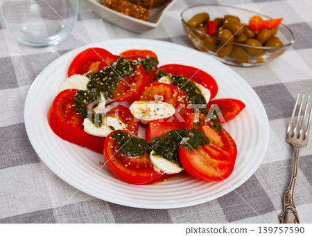 Fresh italian caprese salad with mozzarella and tomatoes on plate Fresh italian caprese salad with mozzarella and tomatoes on plate 139757590