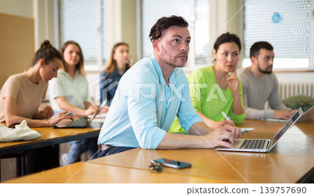Man using laptop during lesson in university Man using laptop during lesson in university 139757690