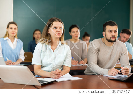 Concentrated students studying in the university auditorium Concentrated students studying in the university auditorium 139757747