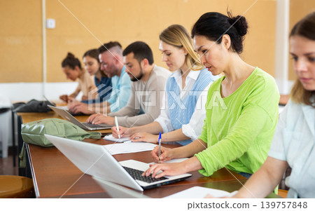 Group students listening and writing during business course Group students listening and writing during business course 139757848