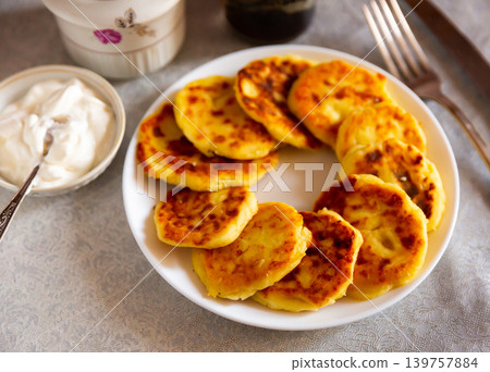 Just cooked syrniki on white plate Just cooked syrniki on white plate 139757884
