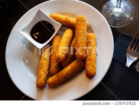 Delicious cheese sticks with mozzarella cheese and sauce Delicious cheese sticks with mozzarella cheese and sauce 139757918
