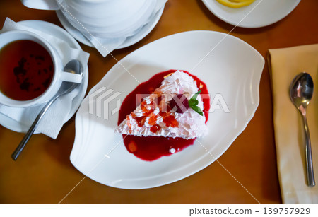 Ice cream cake slice with whipped cream and berry syrup Ice cream cake slice with whipped cream and berry syrup 139757929