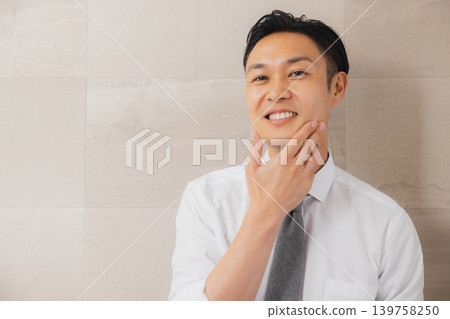 A businessman getting ready in the bathroom. A businessman getting ready in the bathroom. 139758250