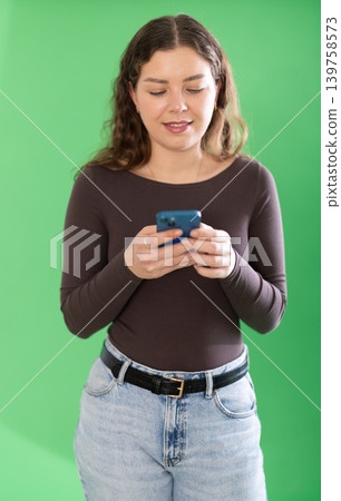 Female person girl scrolls phone screen or types text message 139758573