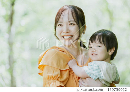 一位母親和孩子在大自然中玩耍。 一位母親和孩子在大自然中玩耍。 139759022