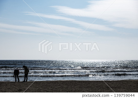 A tranquil coastal landscape with the sea and blue sky stretching out over Inasa Beach. A tranquil coastal landscape with the sea and blue sky stretching out over Inasa Beach. 139759044