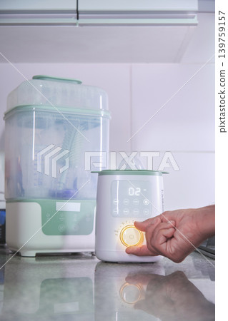 Baby bottle sterilizer and warmer for infant hygiene Baby bottle sterilizer and warmer for infant hygiene 139759157