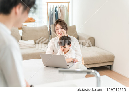 Women working remotely while childcare, men doing housework with their mothers, fathers Women working remotely while childcare, men doing housework with their mothers, fathers 139759213