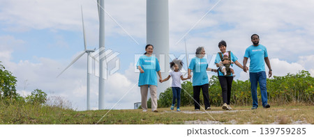 Family with daughter walking on field on wind farm. Family with daughter walking on field on wind farm. 139759285