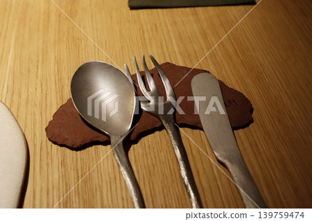 Metal Utensils on Wooden Surface with Stone Accent Metal Utensils on Wooden Surface with Stone Accent 139759474