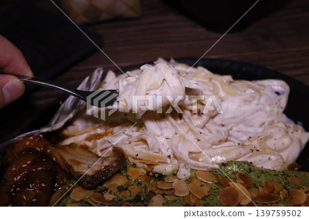 Creamy Pasta Dish with Almonds and Greens 139759502