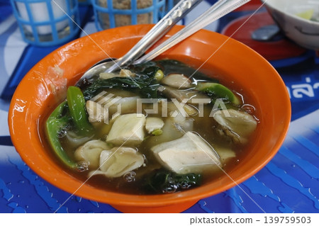 Steaming Tofu and Vegetable Soup in Orange Bowl 139759503