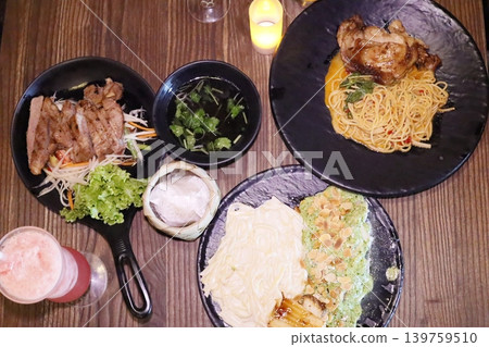 Delicious Asian Cuisine Plated on Dark Plates Delicious Asian Cuisine Plated on Dark Plates 139759510