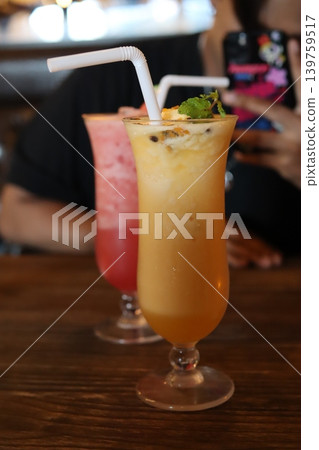 Vibrant Cocktails with Straw and Mint Garnish 139759517