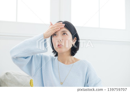 A woman suffering from a headache 139759707