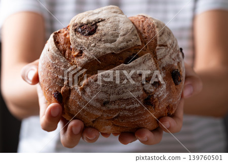 Cranberry sourdough bread holding by woman hand, Homemade bakery and healthy eating Cranberry sourdough bread holding by woman hand, Homemade bakery and healthy eating 139760501