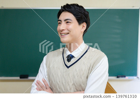 A Japanese male teacher with his arms crossed in the classroom. A Japanese male teacher with his arms crossed in the classroom. 139761310
