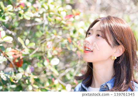 A Japanese woman's profile as she looks up at nature. A Japanese woman's profile as she looks up at nature. 139761345