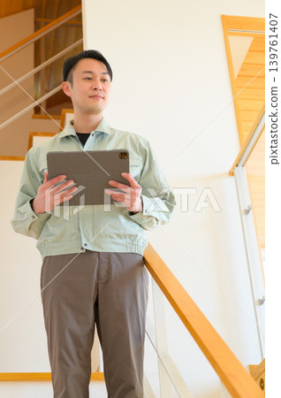 Japanese male worker holding a tablet Japanese male worker holding a tablet 139761407