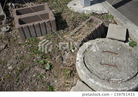 Sewer cover and block in the backyard Sewer cover and block in the backyard 139761433