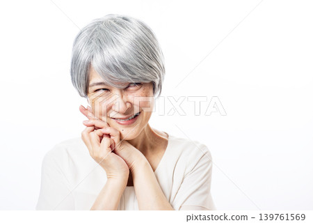 A senior woman with white hair, grinning and waiting for an opportunity. 139761569