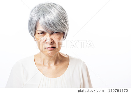 An elderly woman with a dejected expression 139761570