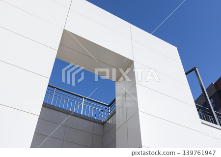 Minimal modern architecture featuring a white geometric facade Minimal modern architecture featuring a white geometric facade 139761947