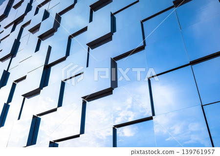 Contemporary glass facade of a building featuring repeating geometric pattern Contemporary glass facade of a building featuring repeating geometric pattern 139761957