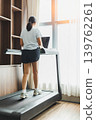 Active woman walking on a treadmill at home gym. 139762261