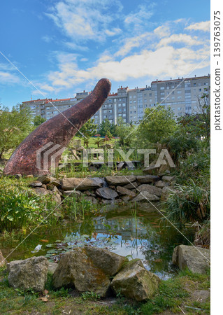 Earthworm tail sculpture with mosaics next to a pond in Minoca Park in Vigo Earthworm tail sculpture with mosaics next to a pond in Minoca Park in Vigo 139763075