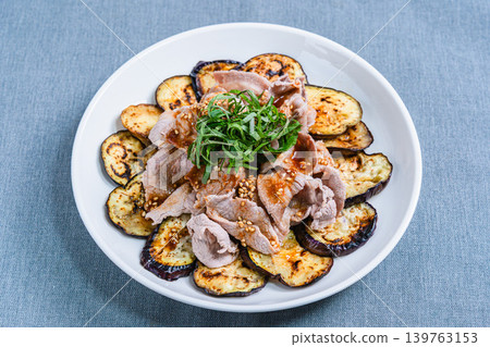 Grilled eggplant topped with pork shabu-shabu placed on the table Grilled eggplant topped with pork shabu-shabu placed on the table 139763153