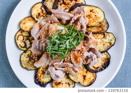 Grilled eggplant topped with pork shabu-shabu placed on the table Grilled eggplant topped with pork shabu-shabu placed on the table 139763158