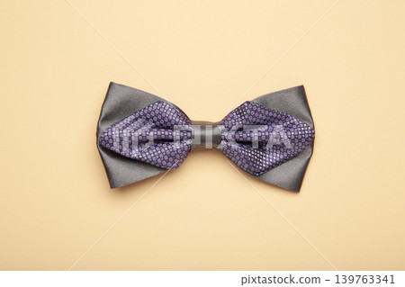 Elegant grey bow tie on beige background. Elegant grey bow tie on beige background. 139763341