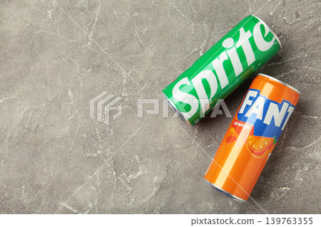 Mykolaiv, Ukraine - March 25, 2026: Iron cans of Fanta and Sprite drink on grey concrete background. Mykolaiv, Ukraine - March 25, 2026: Iron cans of Fanta and Sprite drink on grey concrete background. 139763355