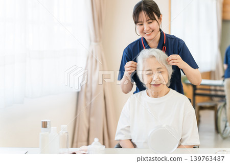 Senior women receiving hair styling at nursing home, nursing beauty salon Senior women receiving hair styling at nursing home, nursing beauty salon 139763487