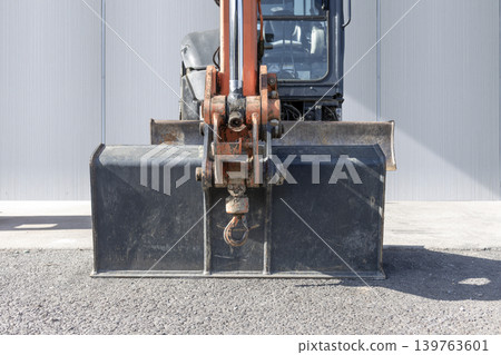 Close-up of a hydraulic excavator attachment and bucket. Close-up of a hydraulic excavator attachment and bucket. 139763601