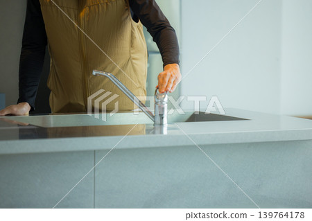 A male craftsman wearing an air-conditioned suit having a meeting while looking at documents A male craftsman wearing an air-conditioned suit having a meeting while looking at documents 139764178