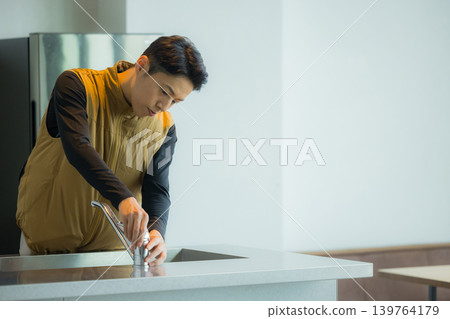 A male craftsman wearing an air-conditioned suit having a meeting while looking at documents A male craftsman wearing an air-conditioned suit having a meeting while looking at documents 139764179