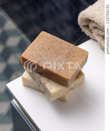 Beige soap with blank paper label mockup with beige towel in blue bathroom. Unbranded packaging Beige soap with blank paper label mockup with beige towel in blue bathroom. Unbranded packaging 139764295
