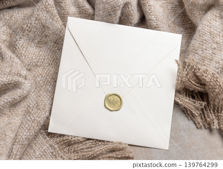 Blank envelope mockup with envelope on grey stone and beige blanket, copy space. Stationery template 139764299
