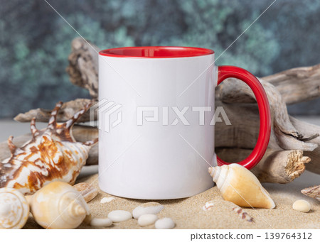 Accent mug mockup, ceramic 11oz mug with red handle on sand with seashells and driftwood 139764312