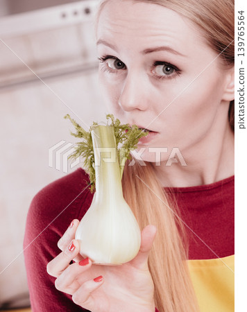 Happy woman holding green fennel Happy woman holding green fennel 139765564